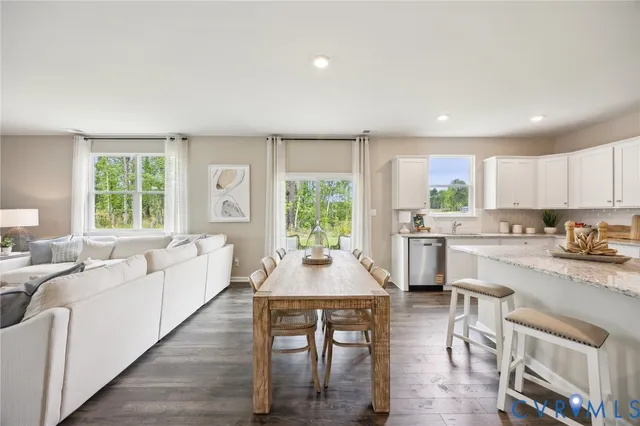 a kitchen with a table chairs stove and cabinets