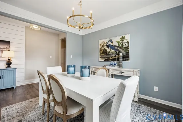 a view of a dining room with furniture wooden floor and chandelier