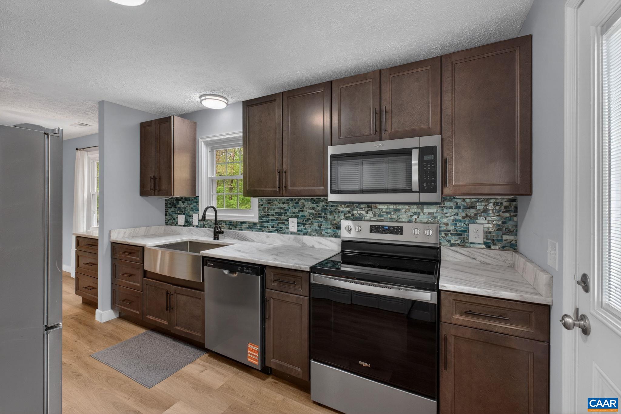 673 Cedar Lane Road Palmyra, VA 22963 - Photo 12 of 47 a kitchen with a sink stove and microwave