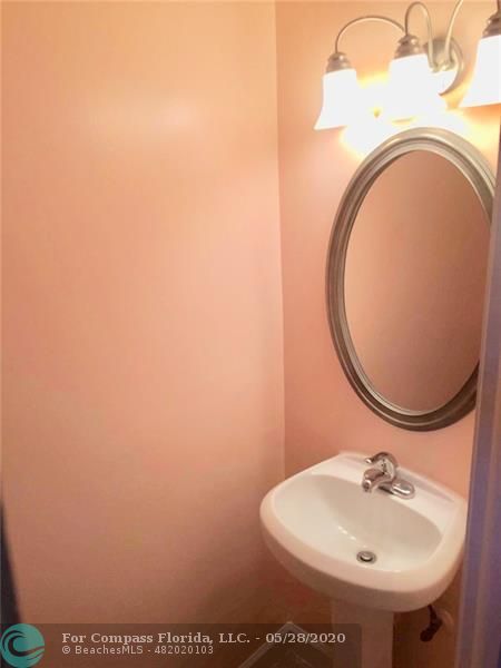 3321 Quail Close Pompano Beach, FL 33064 - Photo 7 of 9 a bathroom with a sink and a mirror