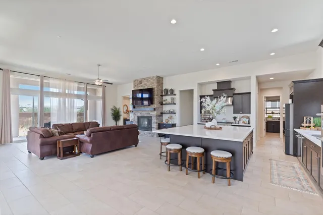 a living room with furniture a flat screen tv and a large window