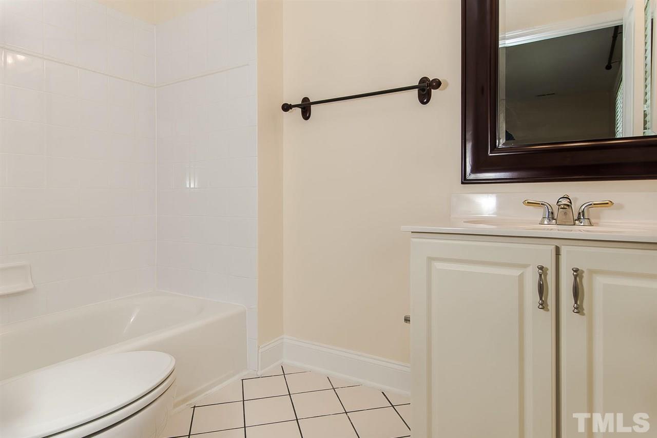 9001 Winged Thistle Court Raleigh, NC 27617 - Photo 16 of 25 a bathroom with a sink a toilet and bathtub