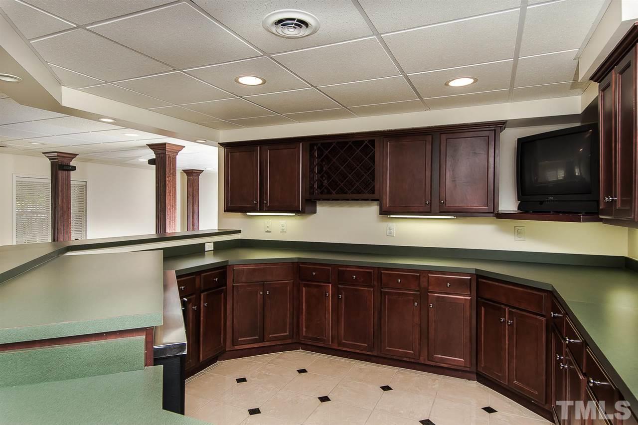 9001 Winged Thistle Court Raleigh, NC 27617 - Photo 19 of 25 a kitchen with a sink appliances and cabinets
