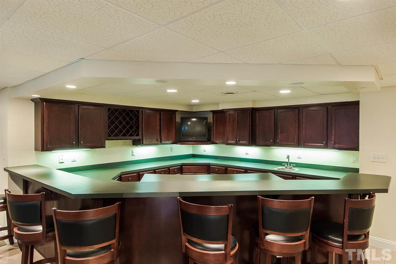 9001 Winged Thistle Court Raleigh, NC 27617 - Photo 20 of 25 a kitchen with a table chairs sink and cabinets