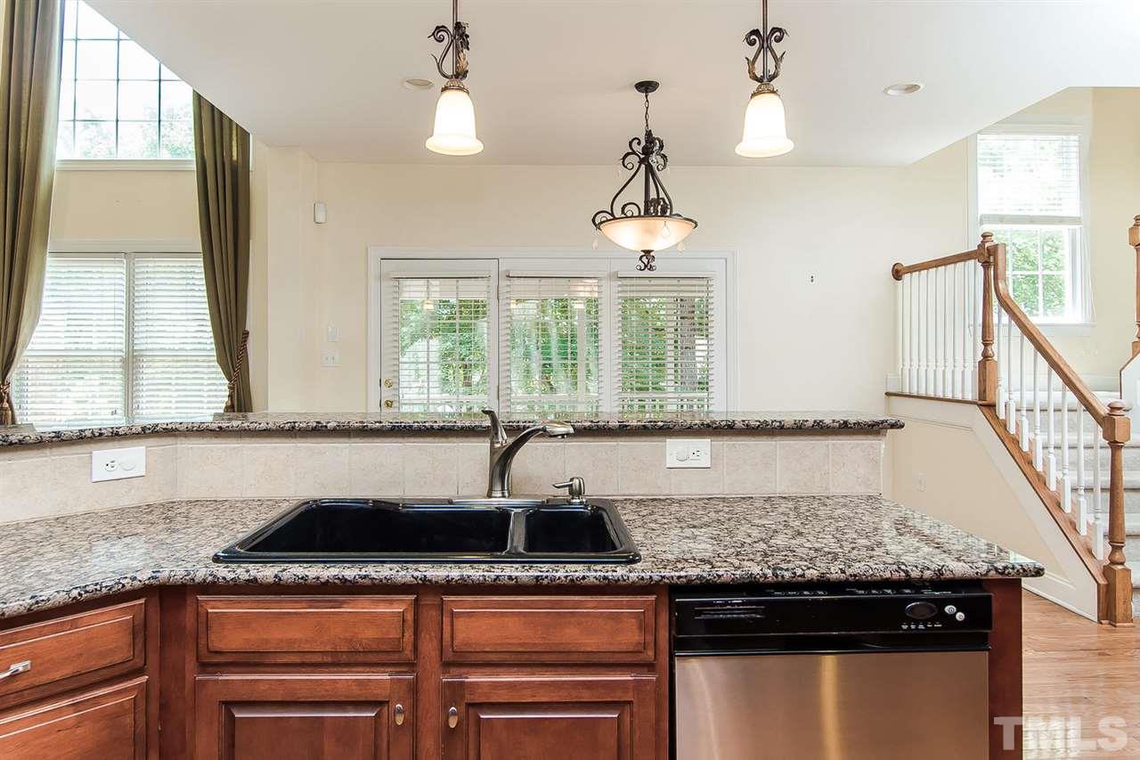 9001 Winged Thistle Court Raleigh, NC 27617 - Photo 3 of 25 a kitchen with a sink a counter space and a window