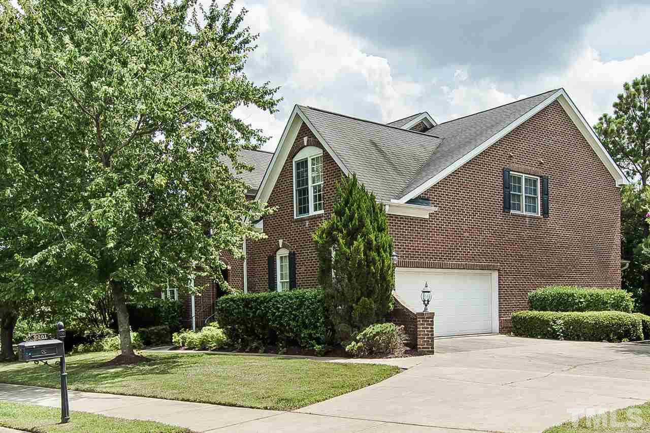 9001 Winged Thistle Court Raleigh, NC 27617 - Photo 25 of 25 a front view of a house with a yard and garage