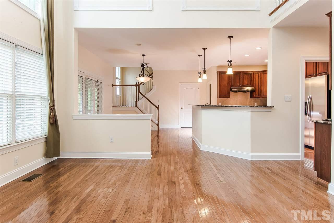 9001 Winged Thistle Court Raleigh, NC 27617 - Photo 4 of 25 wooden floor in an empty room with a window