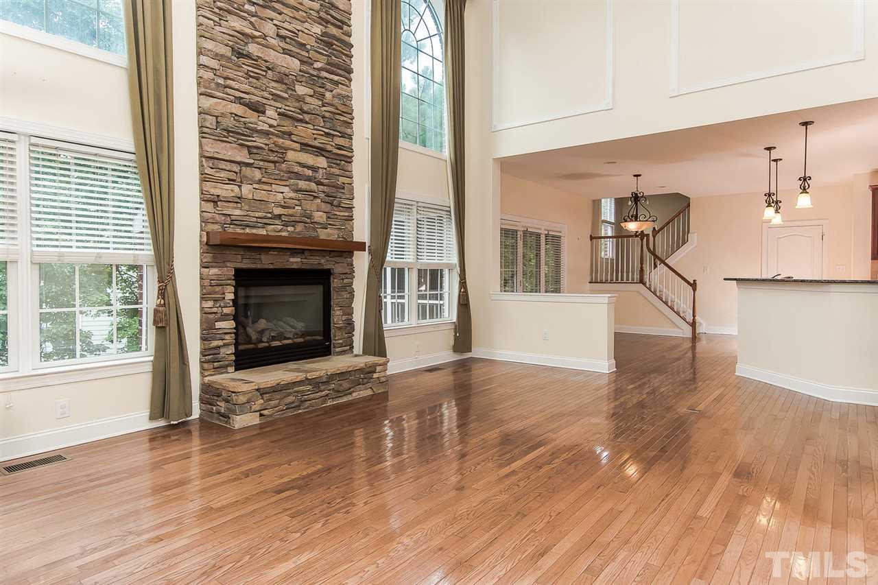 9001 Winged Thistle Court Raleigh, NC 27617 - Photo 6 of 25 a view of a livingroom with wooden floor and a fireplace