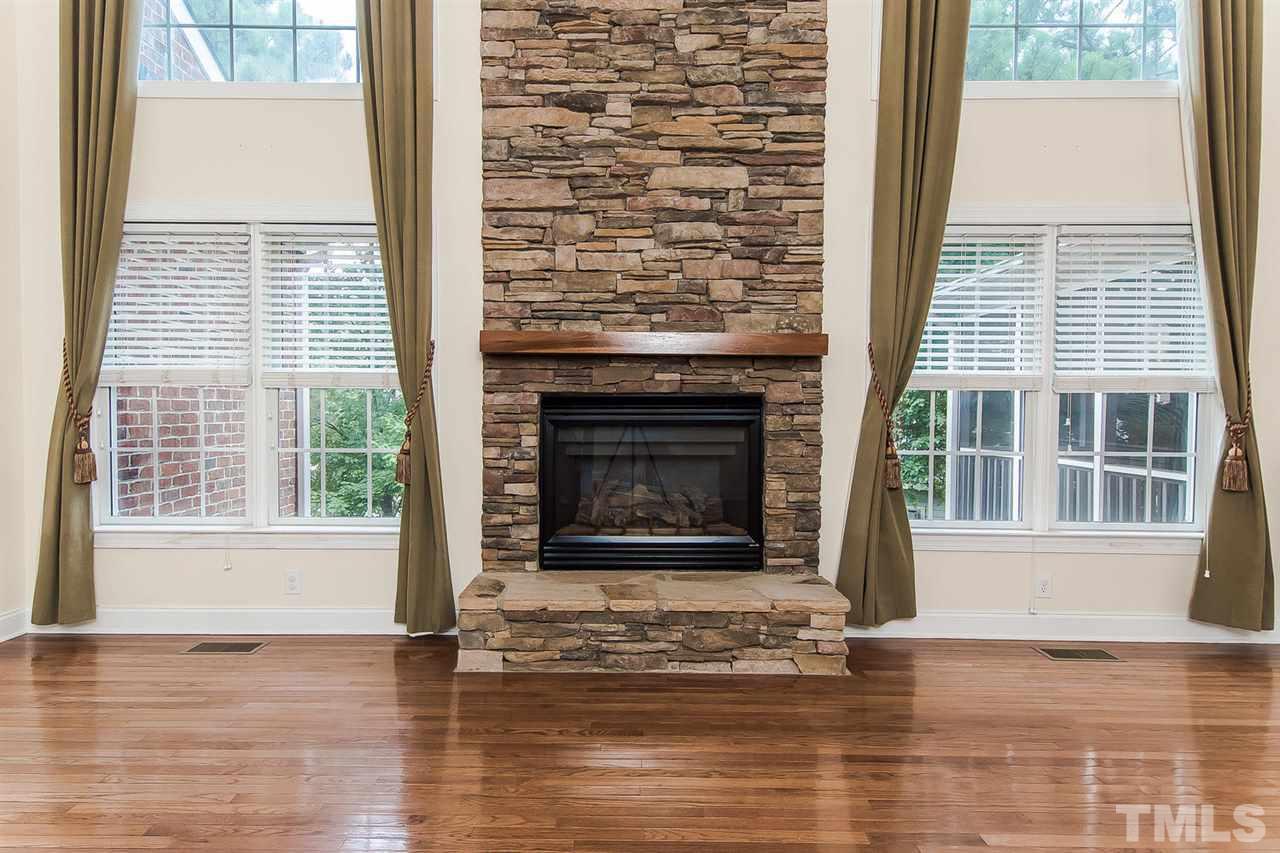 9001 Winged Thistle Court Raleigh, NC 27617 - Photo 7 of 25 a view of an empty room with wooden floor and a window
