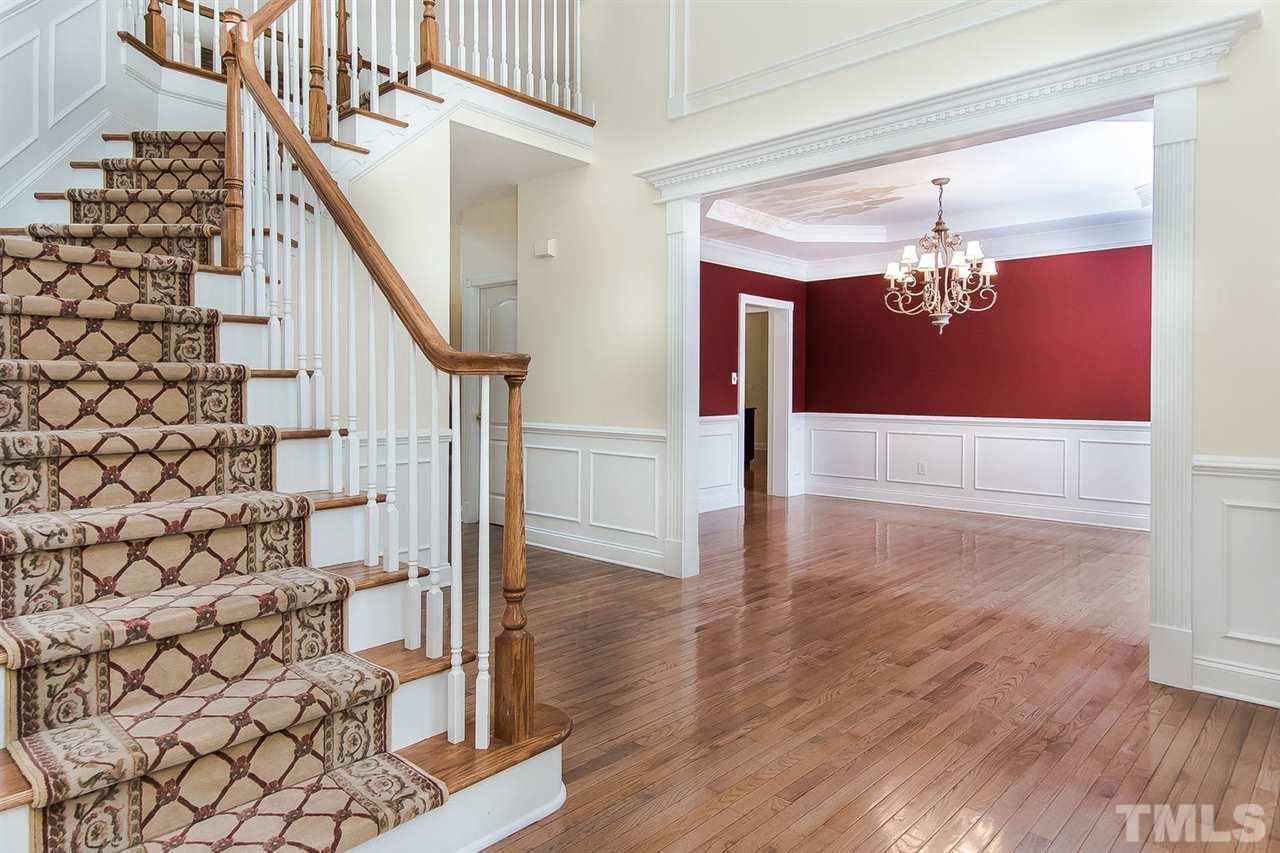 9001 Winged Thistle Court Raleigh, NC 27617 - Photo 9 of 25 a view of a hallway with wooden floor and staircase