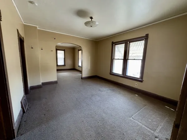 an empty room with windows and closet