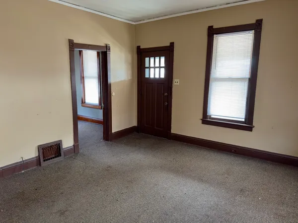 an empty room with windows and closet