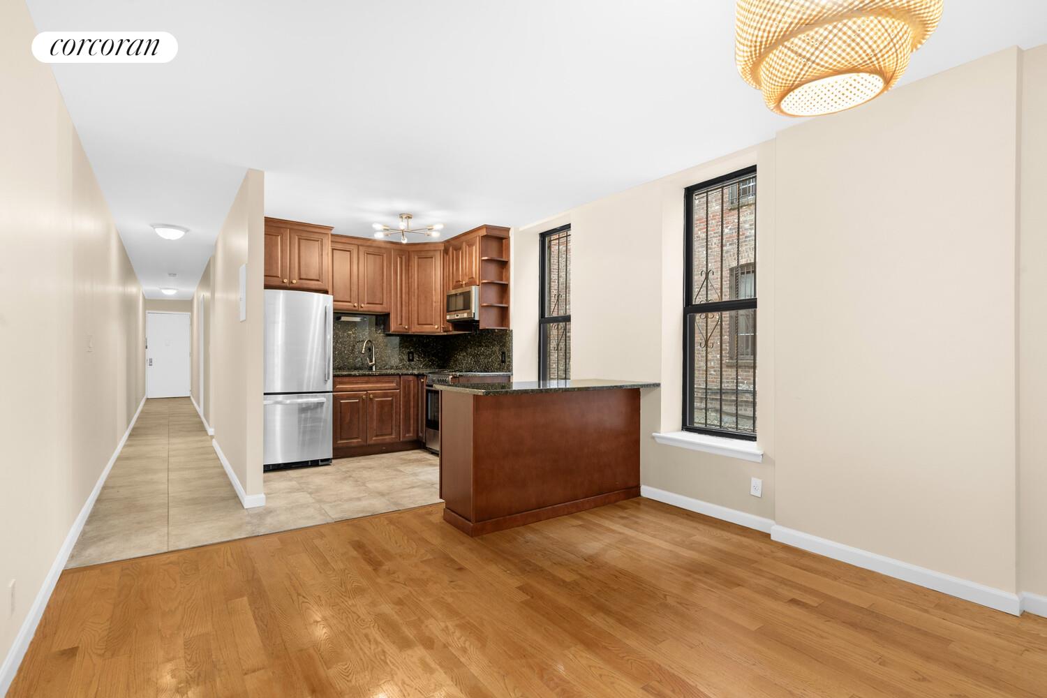 213 Eastern Parkway, Unit 3 Brooklyn, NY 11238 - Photo 2 of 8 a kitchen with stainless steel appliances granite countertop a refrigerator a stove a sink and a microwave