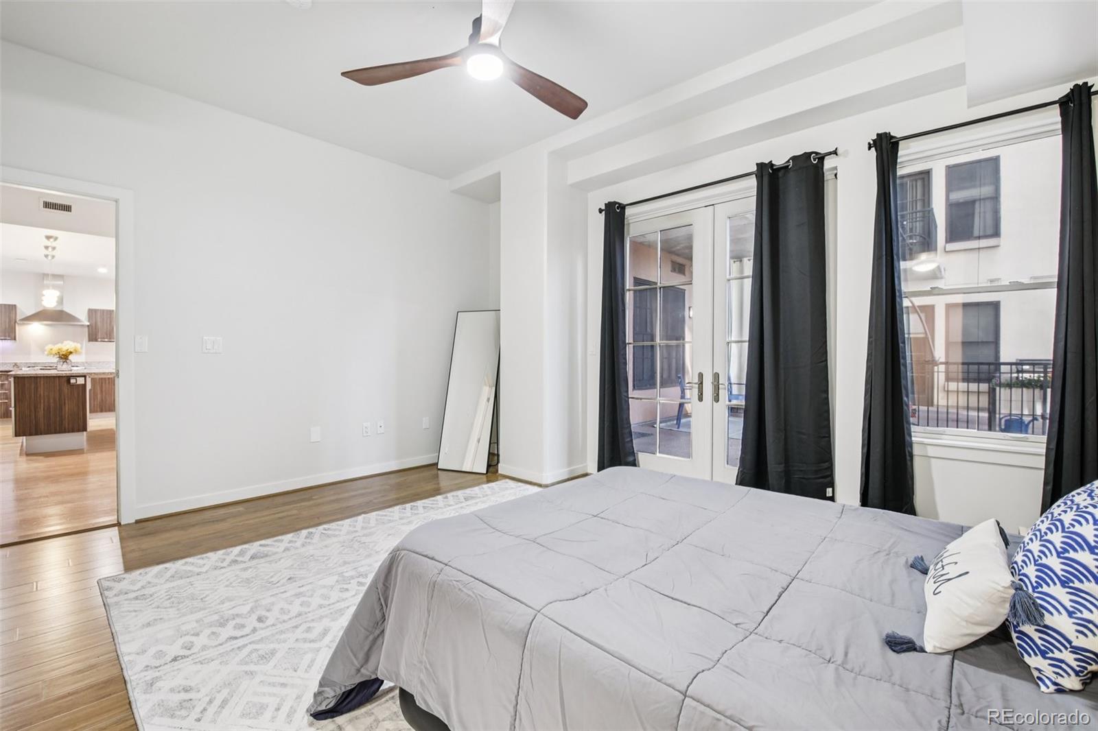 410 Acoma Street, Unit 206 Denver, CO 80204 - Photo 13 of 37 a bedroom with a large bed and a window