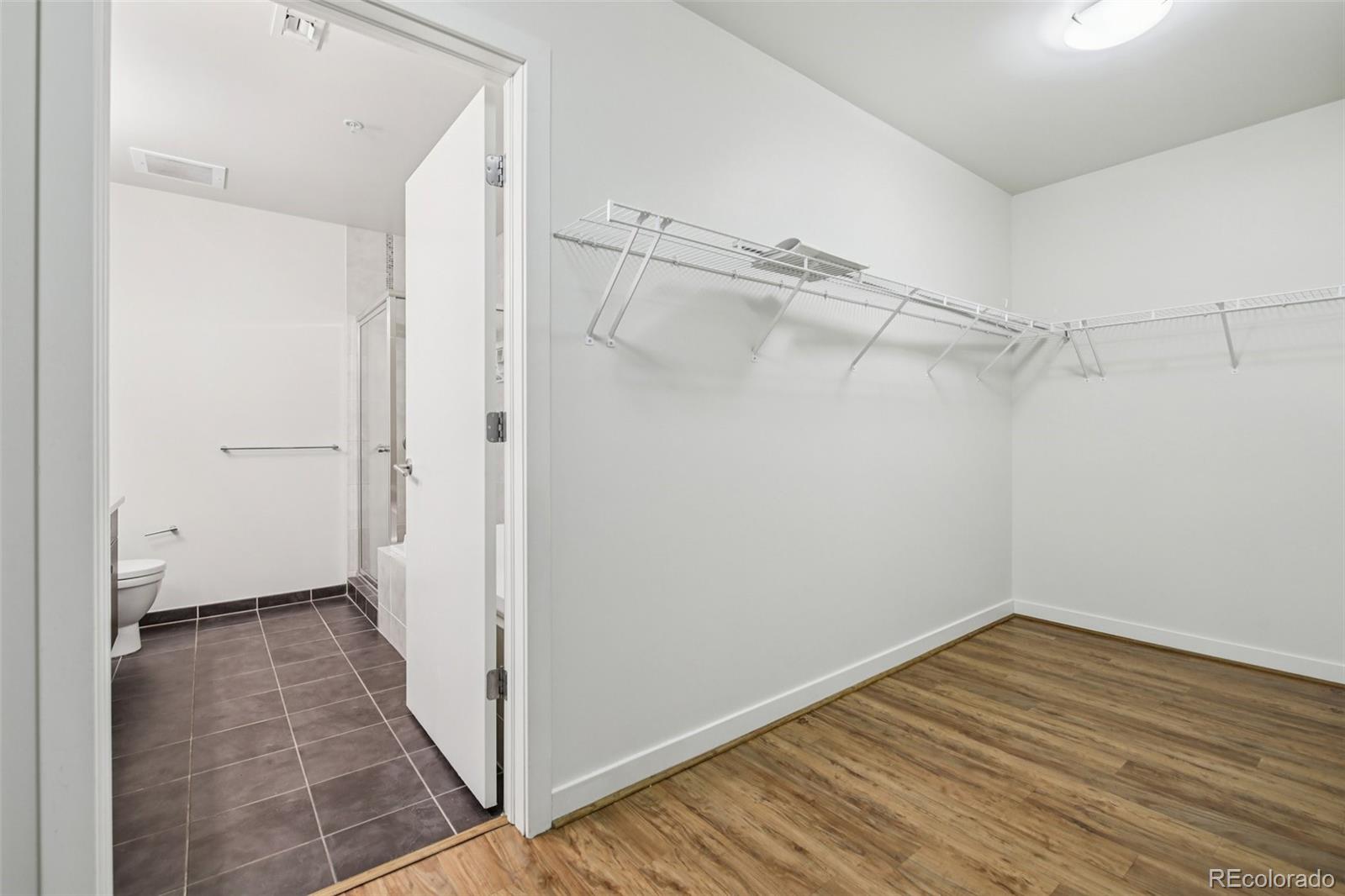 410 Acoma Street, Unit 206 Denver, CO 80204 - Photo 15 of 37 a view of a room with wooden floor and a ceiling fan
