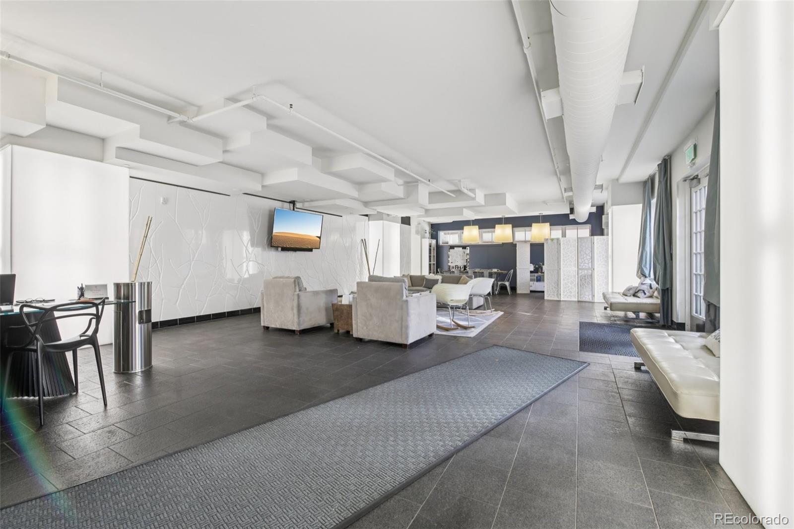 410 Acoma Street, Unit 206 Denver, CO 80204 - Photo 25 of 37 a living room with furniture and a chandelier