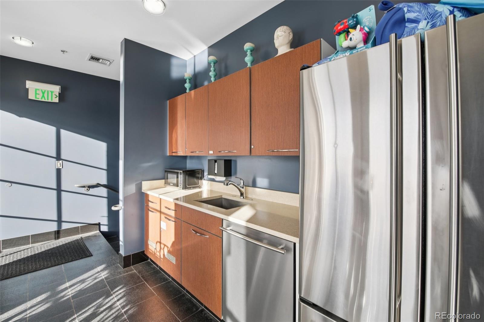 410 Acoma Street, Unit 206 Denver, CO 80204 - Photo 28 of 37 a kitchen with a refrigerator a stove and wooden cabinets