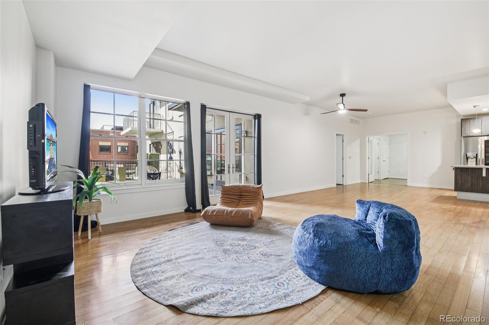 410 Acoma Street, Unit 206 Denver, CO 80204 - Photo 7 of 37 a living room with furniture and a flat screen tv