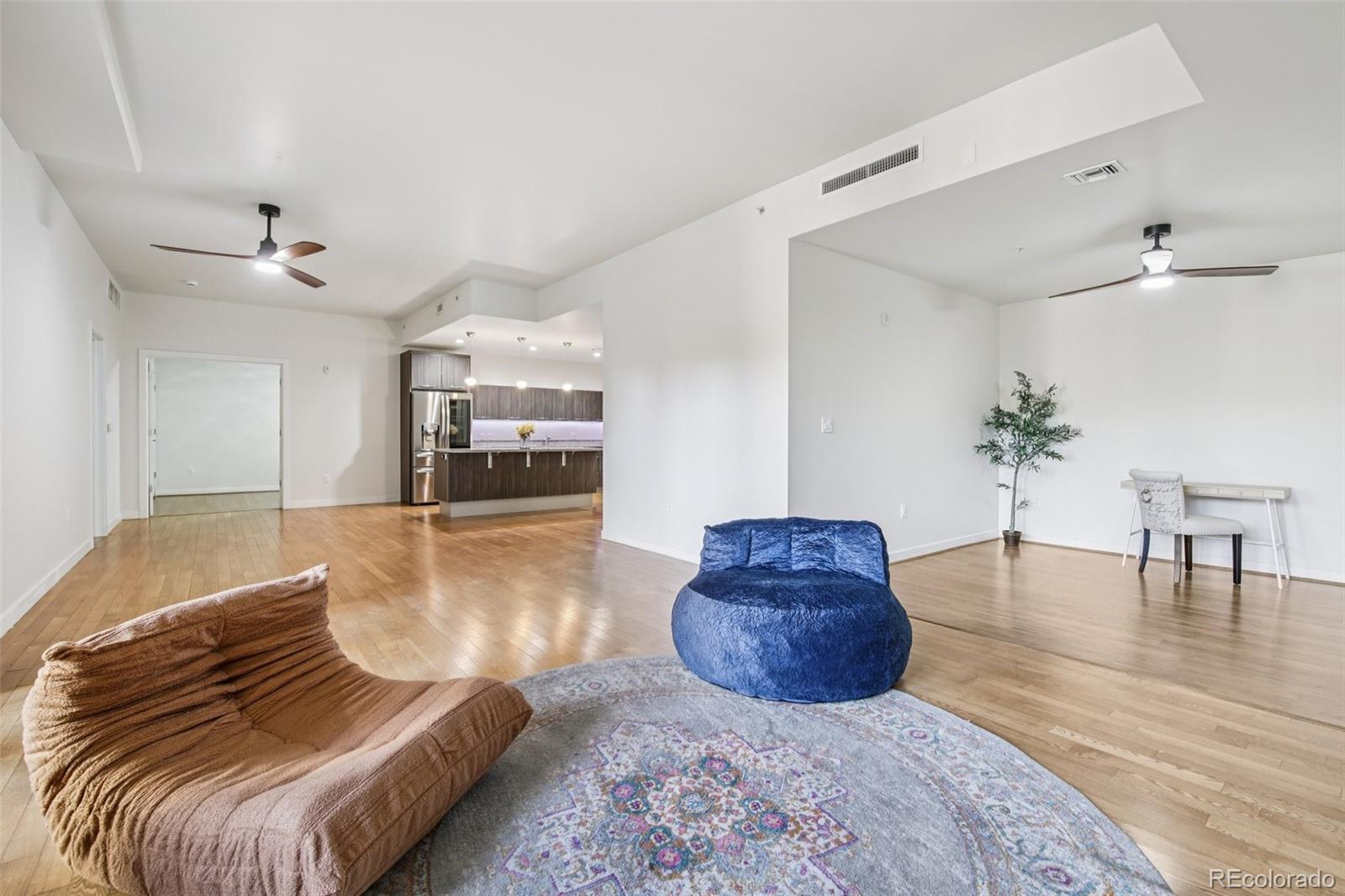 410 Acoma Street, Unit 206 Denver, CO 80204 - Photo 9 of 37 a living room with furniture and wooden floor
