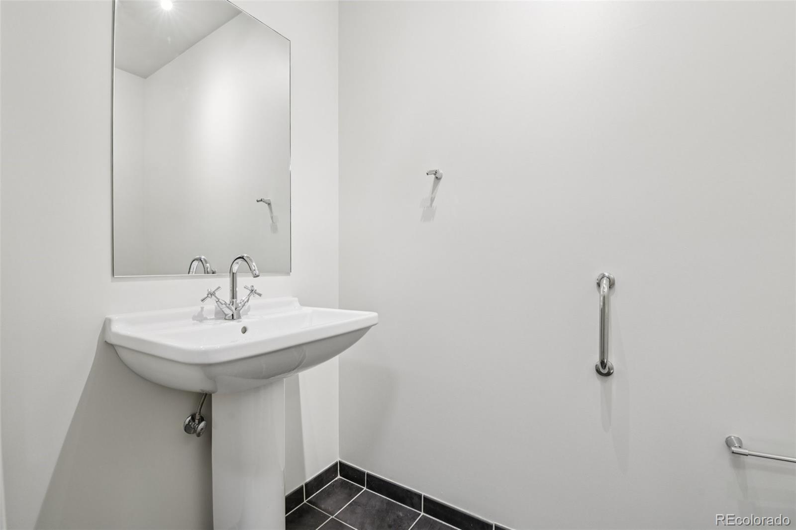 410 Acoma Street, Unit 206 Denver, CO 80204 - Photo 10 of 37 a bathroom with a sink and mirror