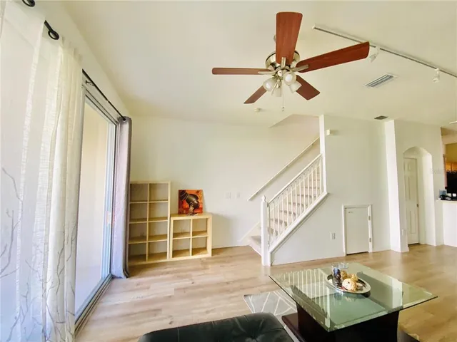 a living room with furniture and wooden floor