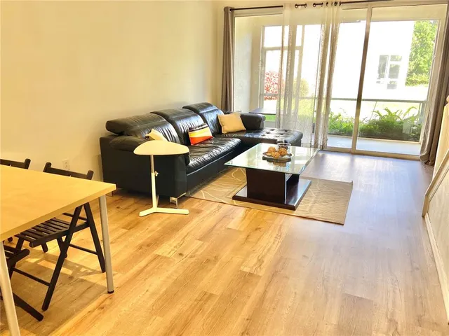 a view of a room with wooden floor and ceiling fan