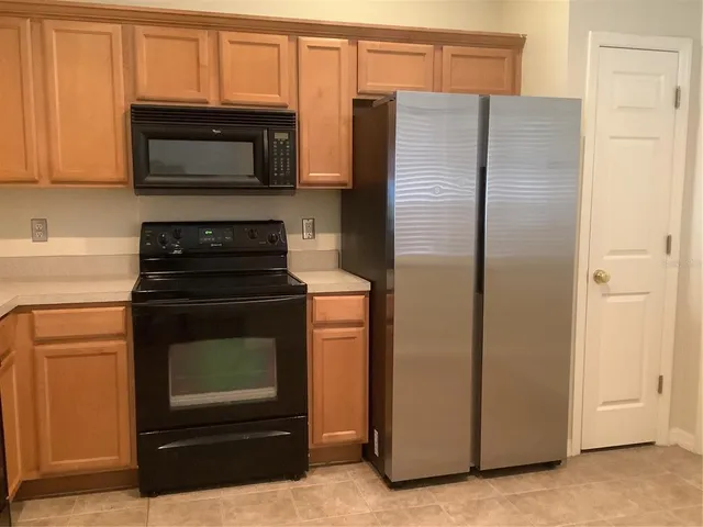 a view of a livingroom with an empty space and a window