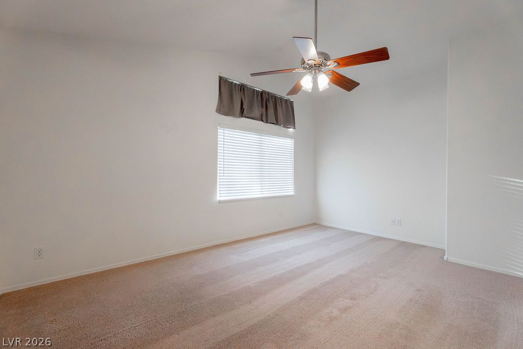 8379 Rockefeller Street Las Vegas, NV 89123 - Photo 20 of 36 Soft carpeting pairs with crisp walls in this light-filled room.