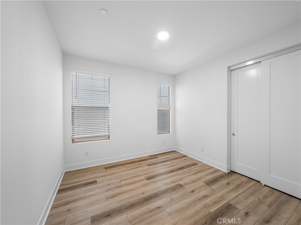 191 Lynx Irvine, CA 92618 - Photo 13 of 24 an empty room with wooden floor and windows
