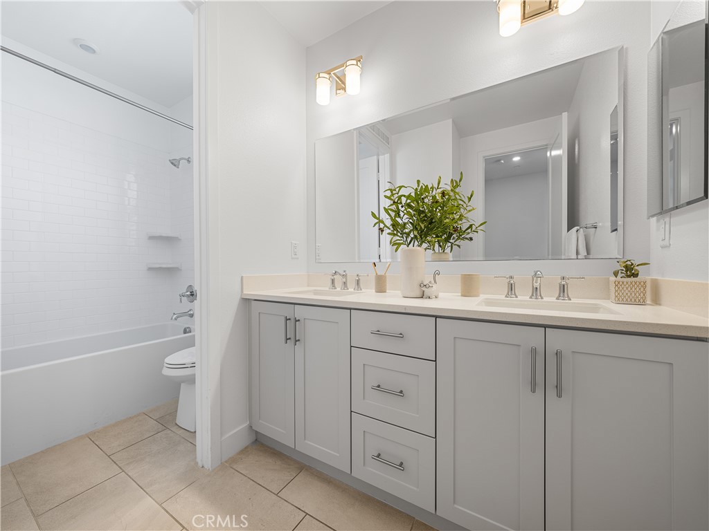 191 Lynx Irvine, CA 92618 - Photo 10 of 24 a bathroom with a double vanity sink toilet and shower