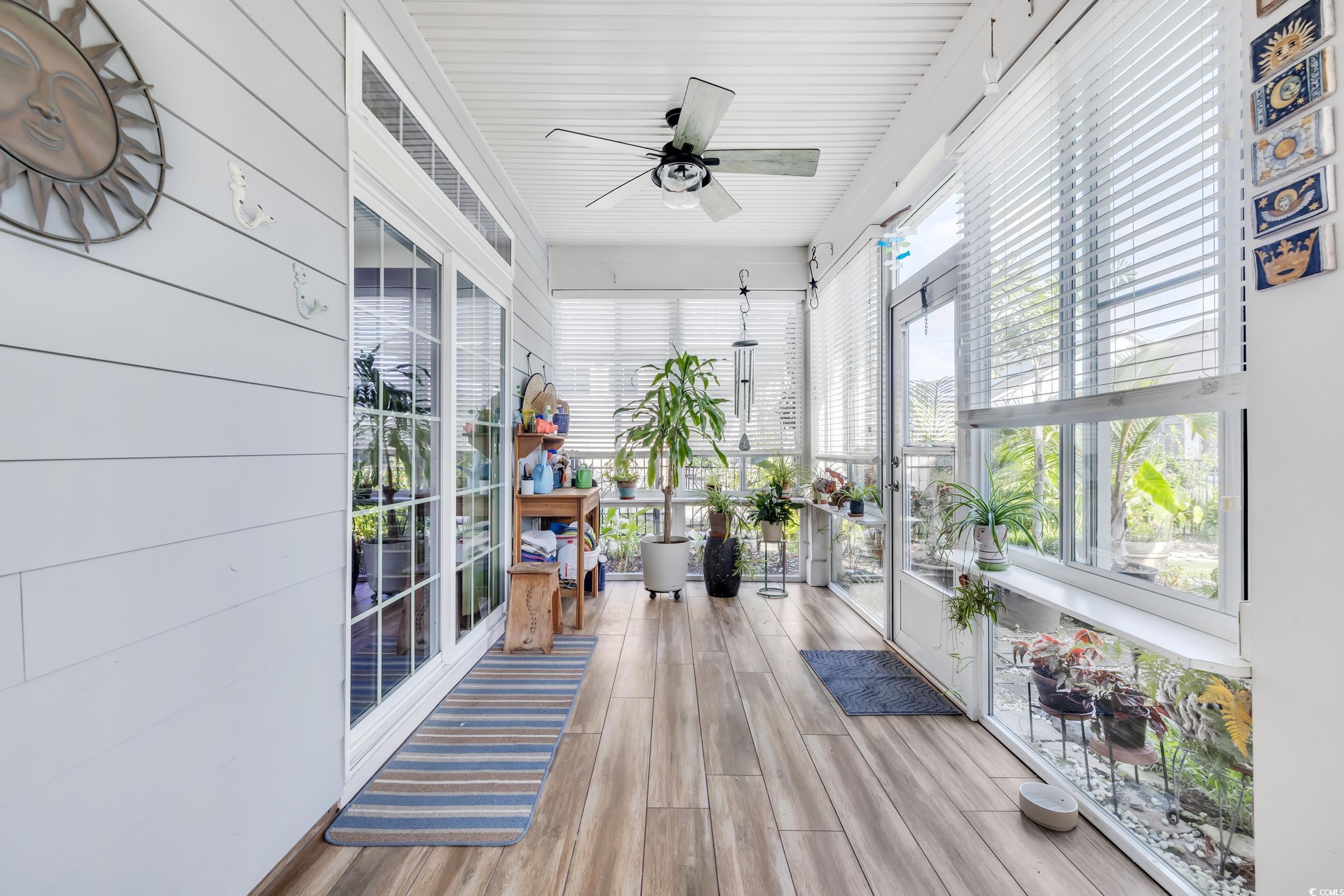 1464 Culbertson Avenue Myrtle Beach, SC 29577 - Photo 12 of 40 Sunroom featuring plenty of natural light, wood finished floors, and wood walls