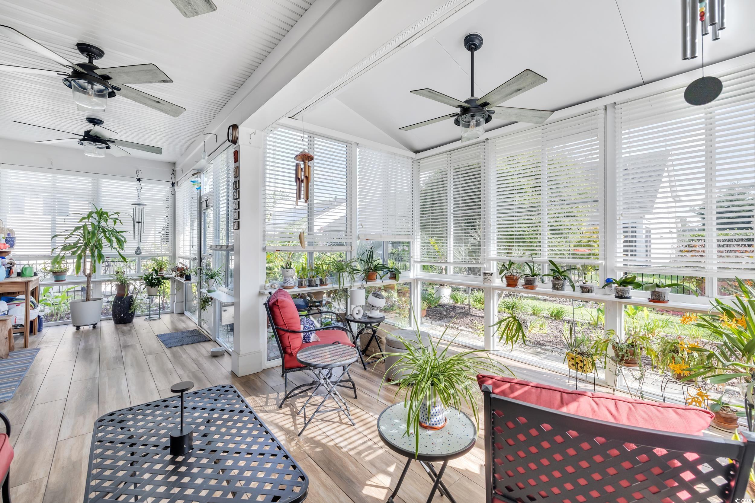 1464 Culbertson Avenue Myrtle Beach, SC 29577 - Photo 14 of 40 Sunroom featuring wood finished floors, healthy amount of natural light, and vaulted ceiling