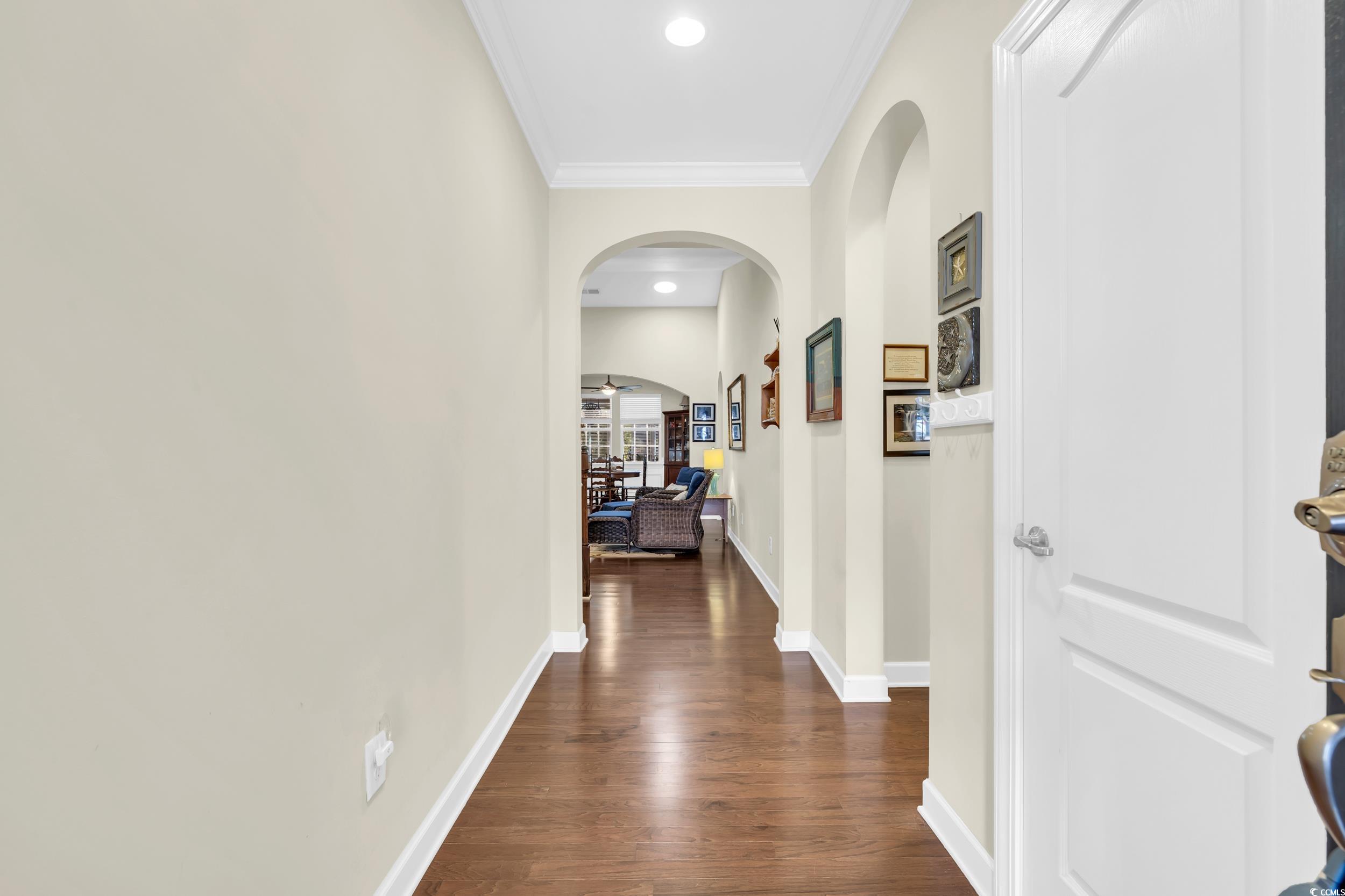 1464 Culbertson Avenue Myrtle Beach, SC 29577 - Photo 2 of 40 Hall with arched walkways, ornamental molding, dark wood-type flooring, and recessed lighting