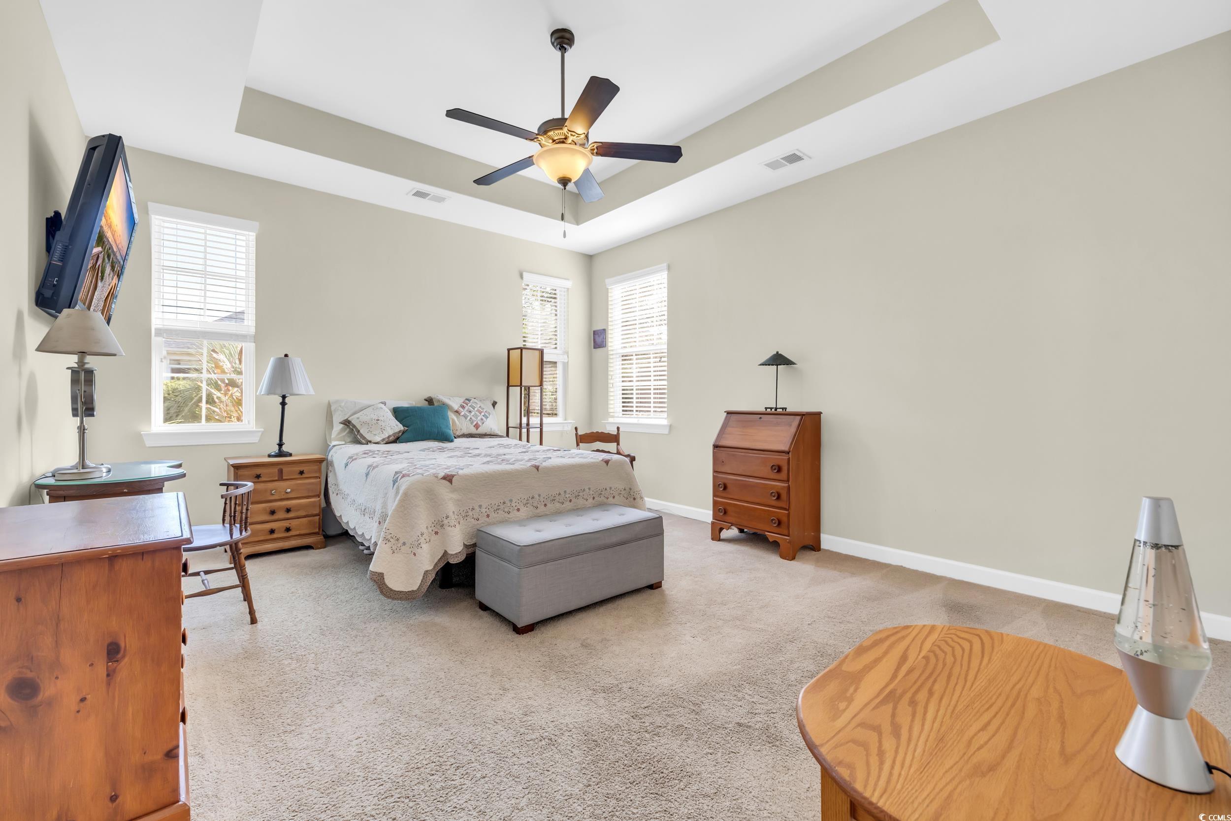 1464 Culbertson Avenue Myrtle Beach, SC 29577 - Photo 22 of 40 Bedroom with a tray ceiling, light colored carpet, and ceiling fan