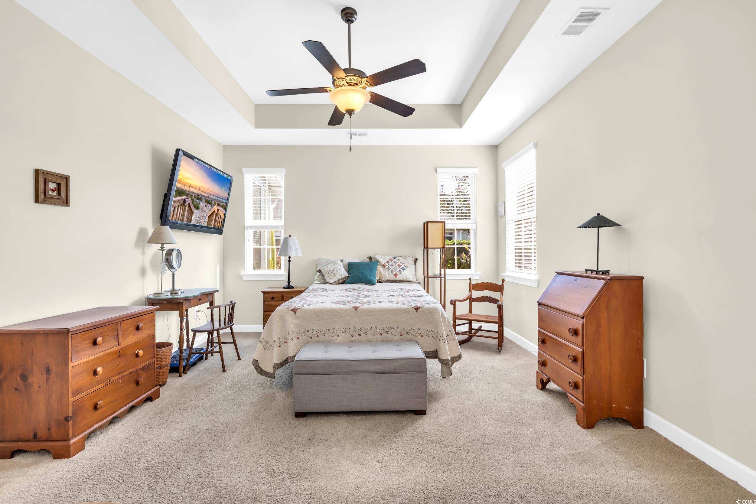 1464 Culbertson Avenue Myrtle Beach, SC 29577 - Photo 23 of 40 Bedroom with light colored carpet, ceiling fan, and a raised ceiling