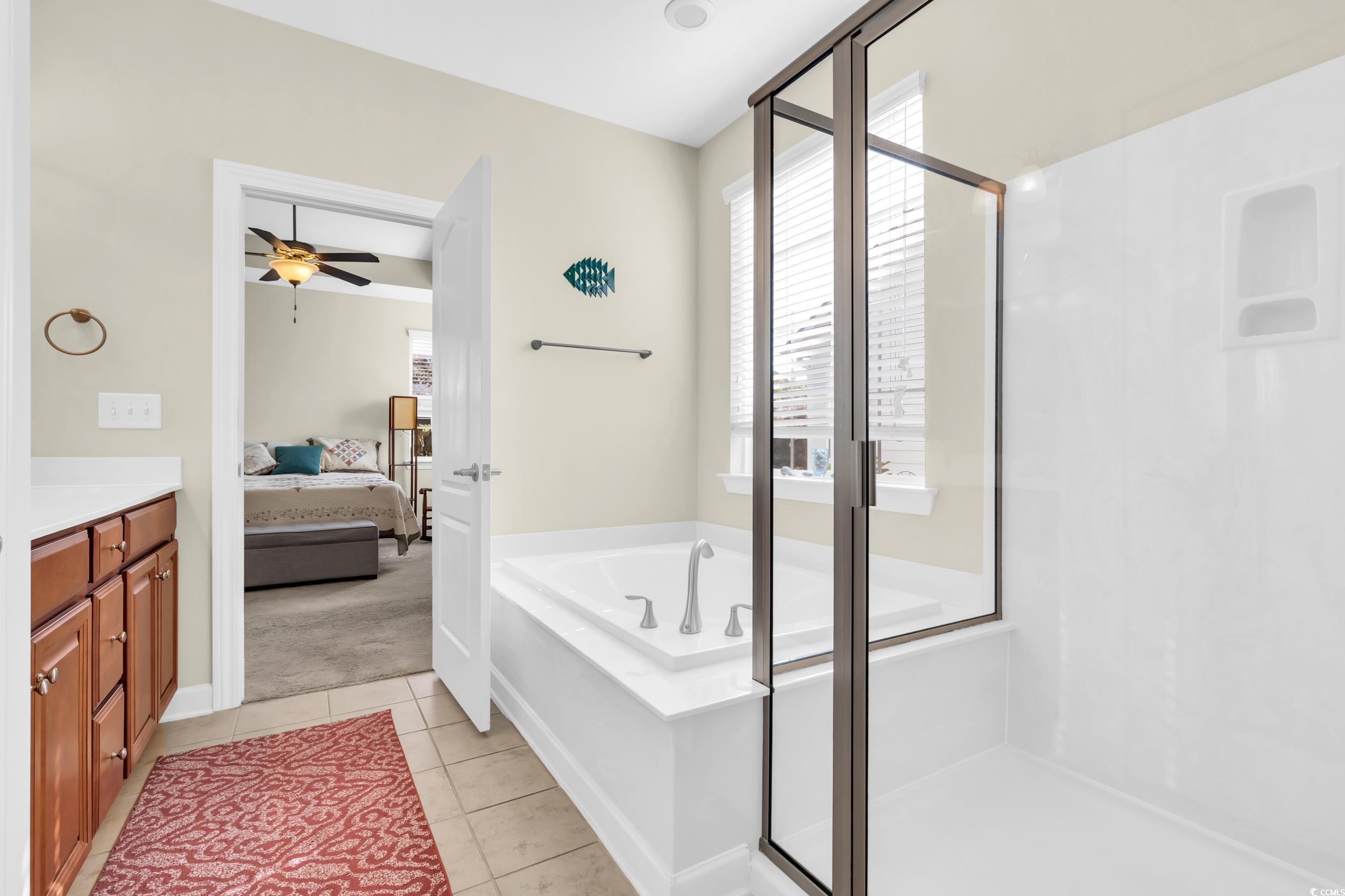 1464 Culbertson Avenue Myrtle Beach, SC 29577 - Photo 25 of 40 Full bath featuring a stall shower, a bath, vanity, ensuite bathroom, and light tile patterned floors