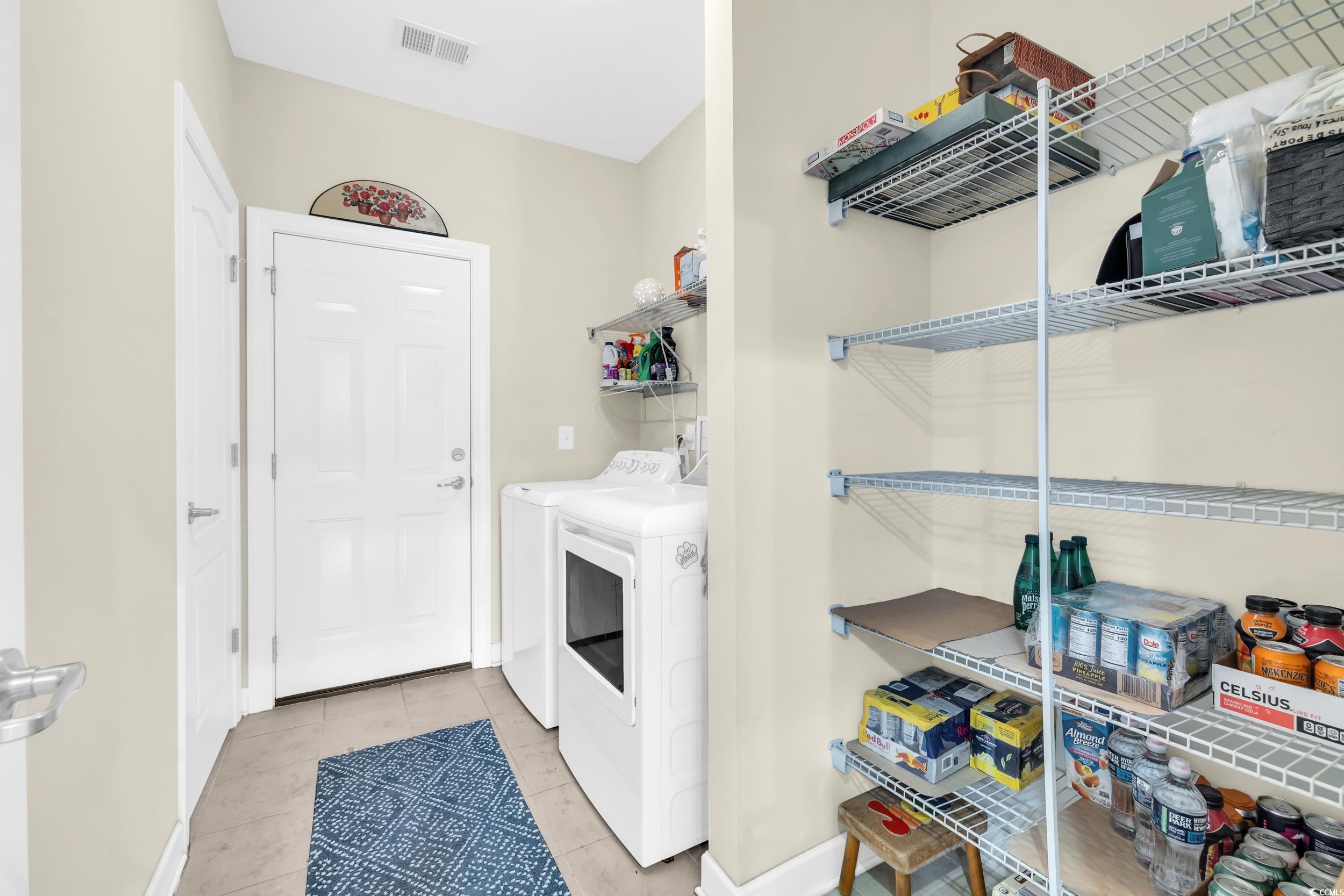 1464 Culbertson Avenue Myrtle Beach, SC 29577 - Photo 29 of 40 Washroom with light tile patterned floors and washer and clothes dryer