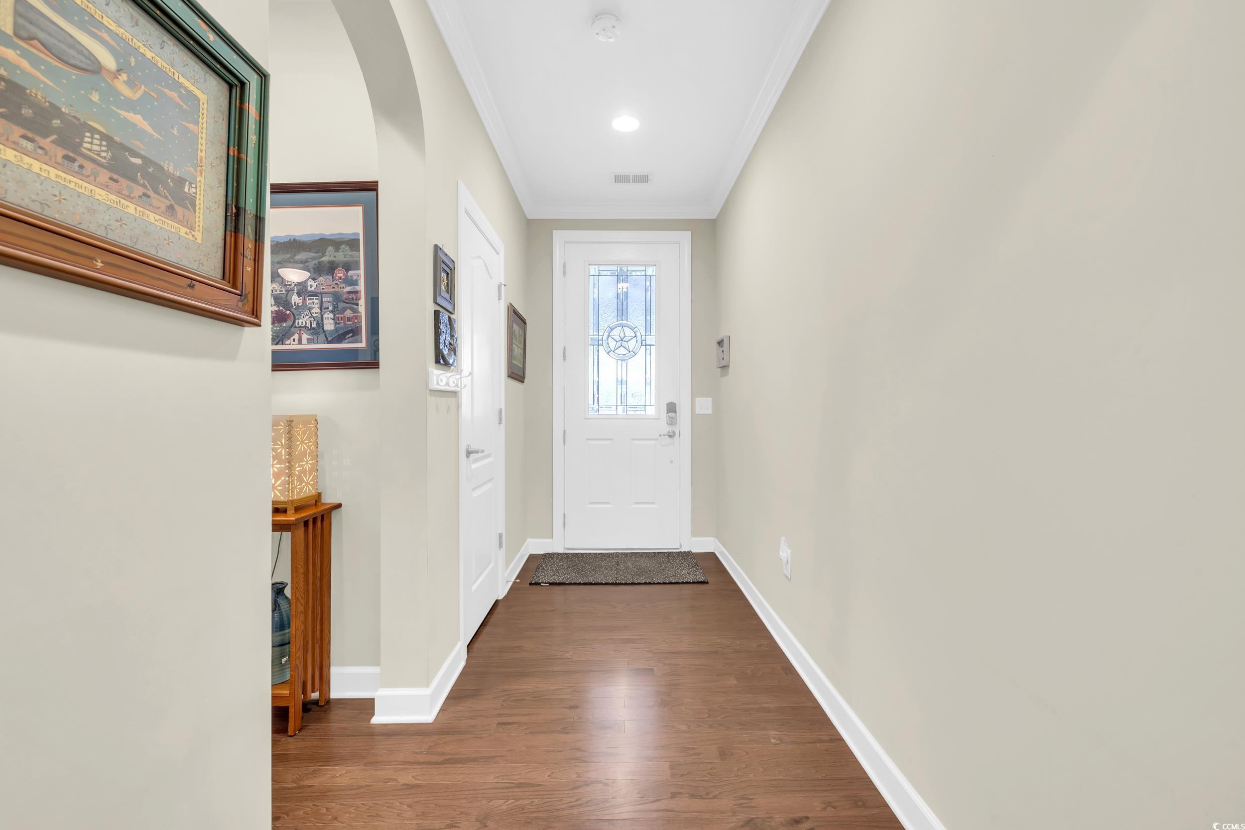 1464 Culbertson Avenue Myrtle Beach, SC 29577 - Photo 3 of 40 Doorway to outside with ornamental molding, wood finished floors, and arched walkways