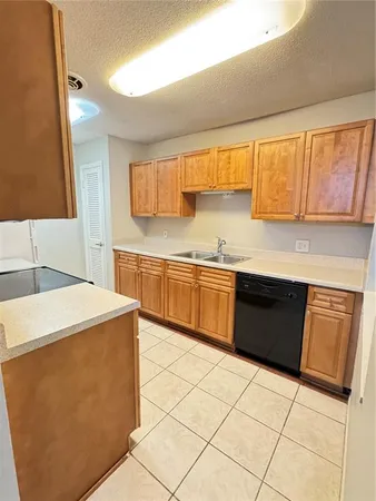 a kitchen with a sink a stove and a microwave oven