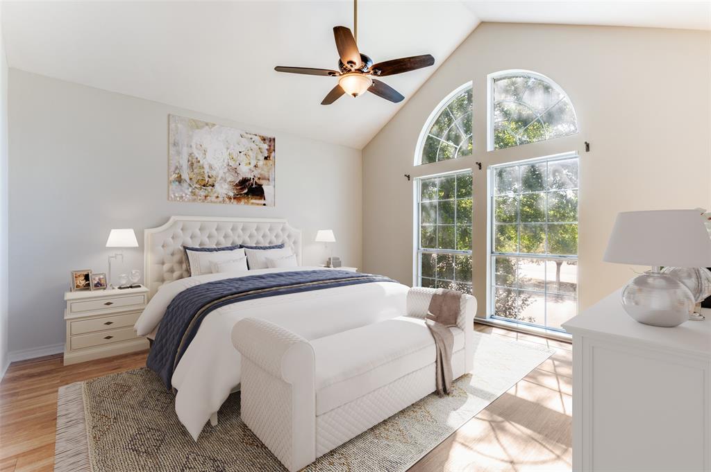 a bedroom with a bed and a large window