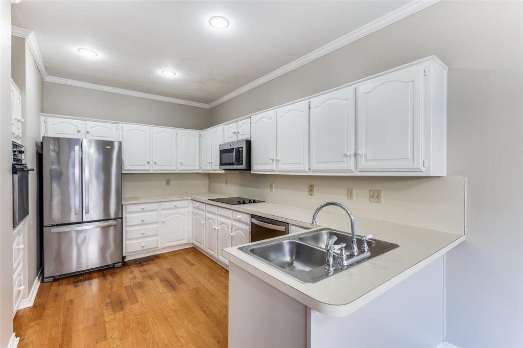 148 Cobblestone Row Denton, TX 76207 - Photo 14 of 37 a kitchen with stainless steel appliances granite countertop a sink stove and refrigerator