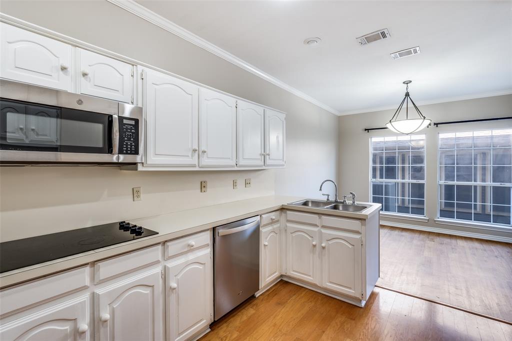 148 Cobblestone Row Denton, TX 76207 - Photo 15 of 37 a kitchen with stainless steel appliances granite countertop a sink and cabinets with wooden floor