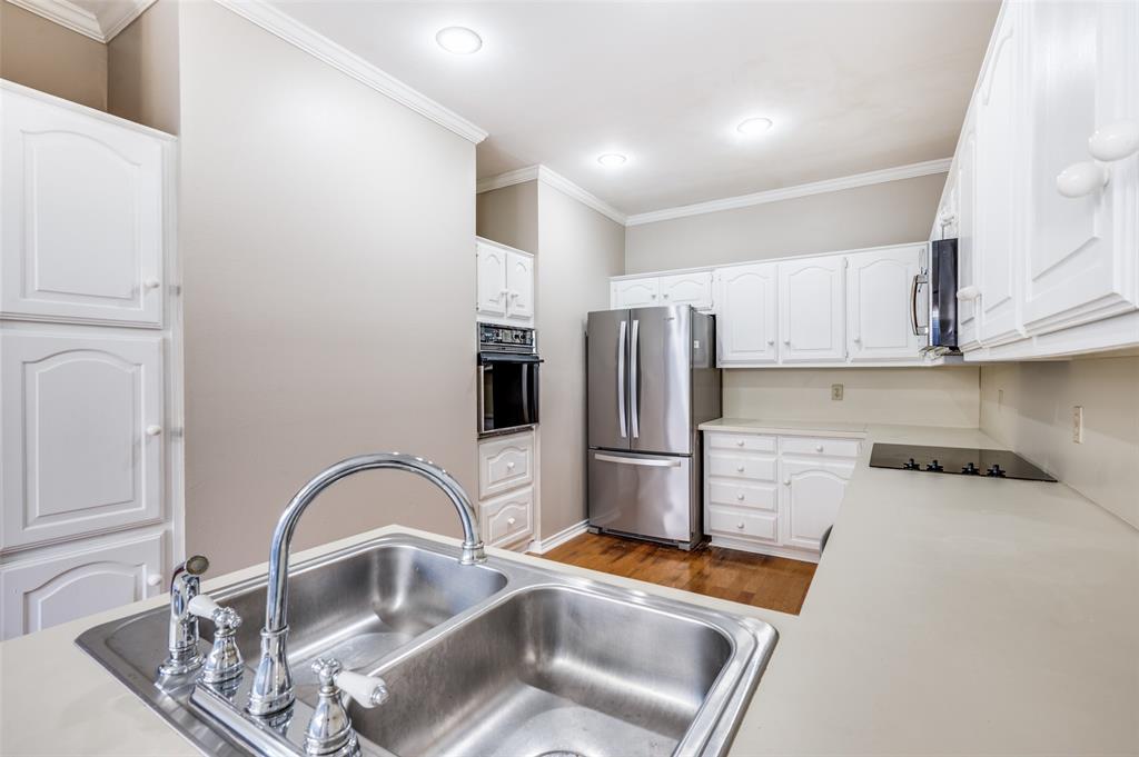 148 Cobblestone Row Denton, TX 76207 - Photo 16 of 37 a kitchen with stainless steel appliances granite countertop a sink a refrigerator and a stove