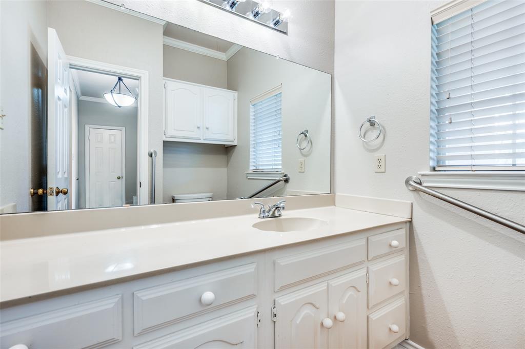 148 Cobblestone Row Denton, TX 76207 - Photo 17 of 37 a bathroom with a sink and a mirror
