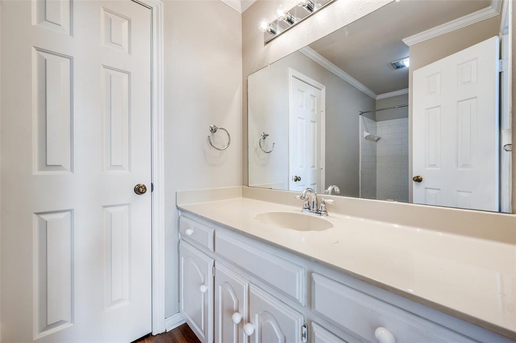 148 Cobblestone Row Denton, TX 76207 - Photo 17 of 33 The primary bathroom also contains a large walk-in closet, accessible through the door on the left.