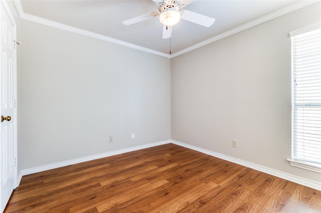 148 Cobblestone Row Denton, TX 76207 - Photo 25 of 37 an empty room with wooden floor and windows