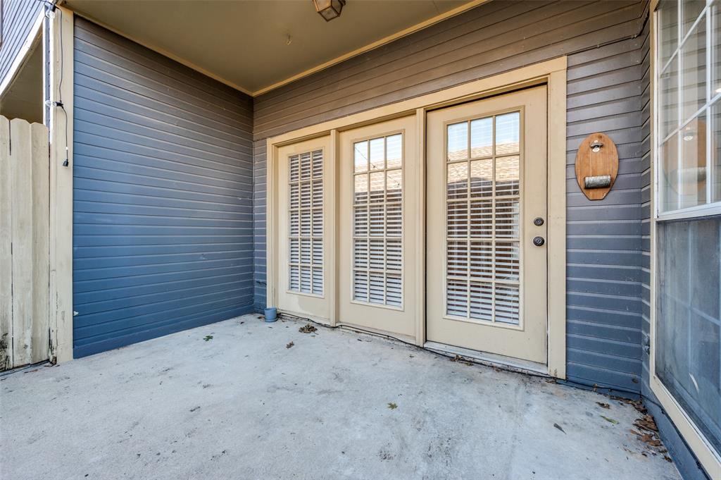148 Cobblestone Row Denton, TX 76207 - Photo 25 of 33 The door pictured is the back door in the living room. It leads out onto a concrete patio in the backyard.