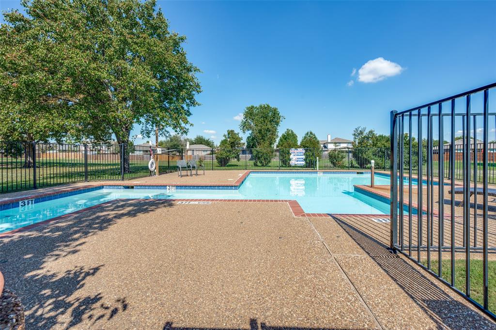 148 Cobblestone Row Denton, TX 76207 - Photo 34 of 37 This fenced-in enclosure contains the community pool that owners of this house will be granted access to.