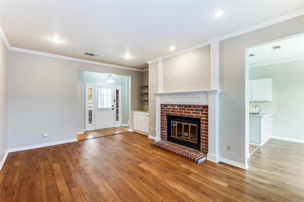148 Cobblestone Row Denton, TX 76207 - Photo 7 of 33 The doorway to the right of the fireplace leads to the dining area and kitchen.