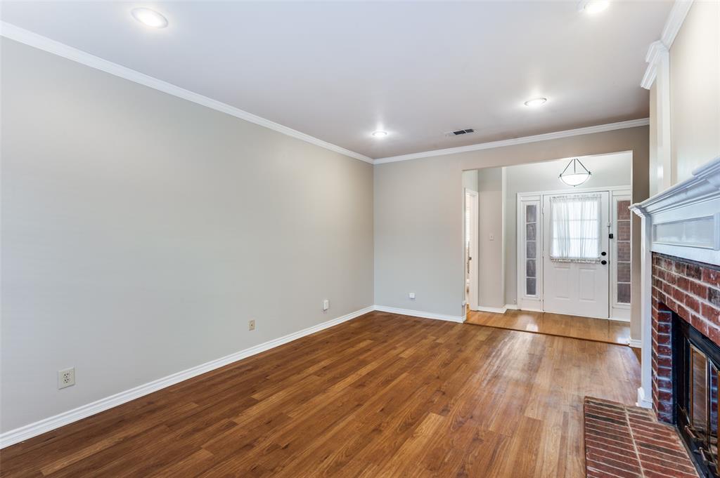 148 Cobblestone Row Denton, TX 76207 - Photo 10 of 37 a view of a room with wooden floor and a fireplace